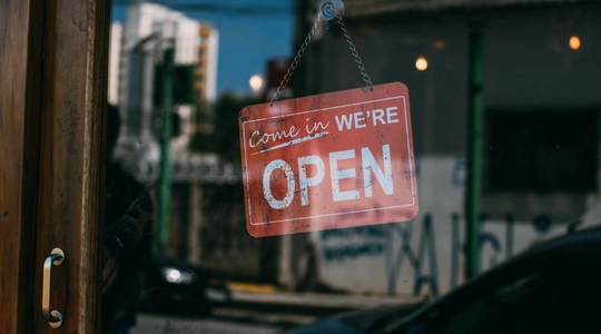 'We're Open' sign on door