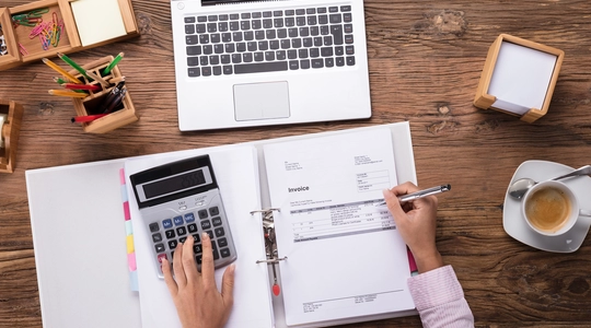 Picture of person working with an Invoice
