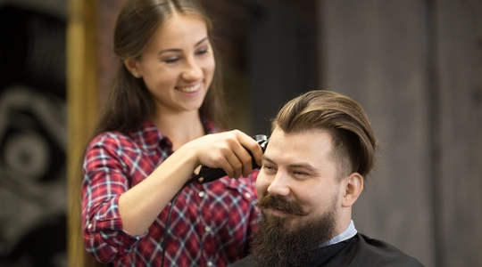 Barber shaving man's head