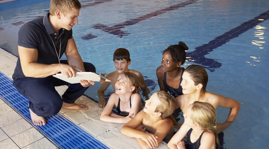 Children having swimming lesson