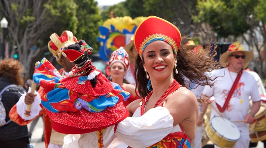 Woman smiling while performing at cultural event