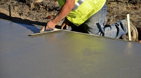 Construction Worker Repairing Sidewalk