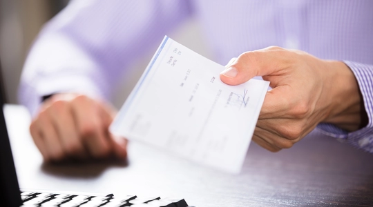 Person holding Cheque