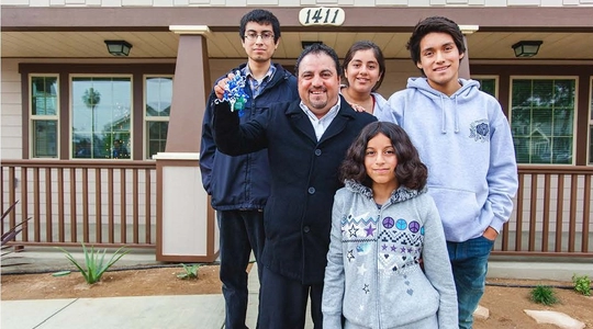 Family standing in front of a house