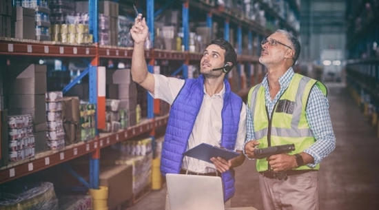 Workers checking inventory in warehouse
