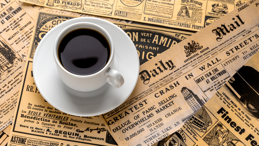 Cup of coffee on top of Daily Mail newspaper
