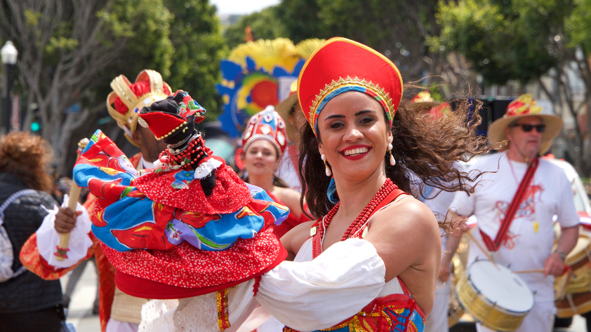 Woman smiling while performing at cultural event