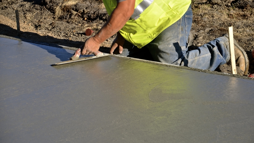 Construction Worker Repairing Sidewalk