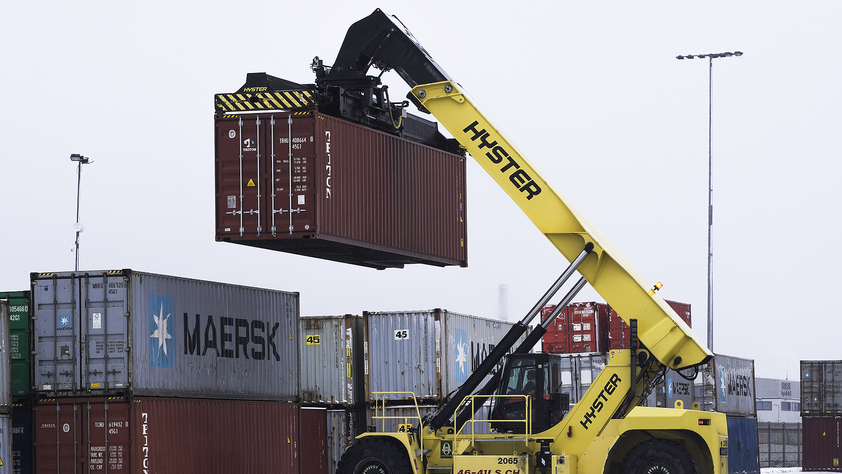 heavy lifting machine lifting a cargo box or shipping container
